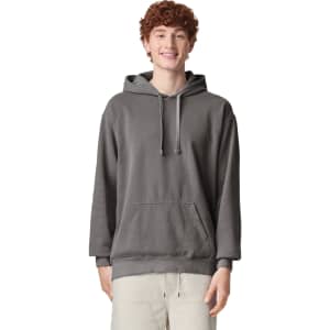 A grey adult hooded sweatshirt with a kangaroo pocket and drawstring hood, featuring a logo.