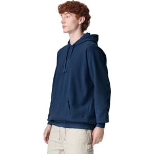A navy hooded sweatshirt with a front pocket, showcasing a simple design and a relaxed fit.