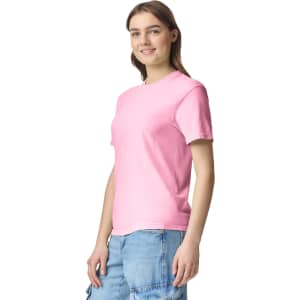 A pink adult heavyweight T-shirt displayed on a model, featuring short sleeves and a relaxed fit.