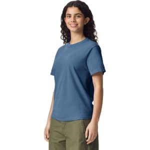 A blue adult heavyweight T-shirt displayed on a model, featuring a simple design and casual fit.