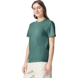 A green heavyweight t-shirt displayed on a model, featuring a logo on the front.