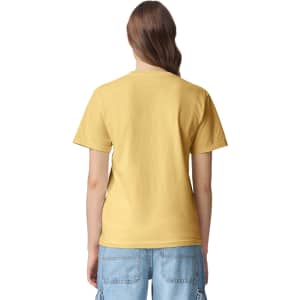 A yellow heavyweight T-shirt featuring a plain back design. The model is wearing casual blue denim shorts.