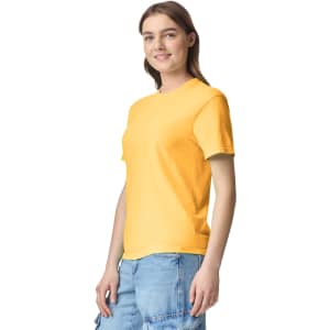 A yellow Adult Heavyweight T-Shirt displayed on a model wearing casual shorts, featuring a logo.