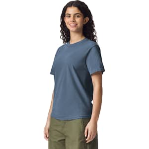 A blue heavyweight adult t-shirt displayed on a model, featuring a logo on the left side.