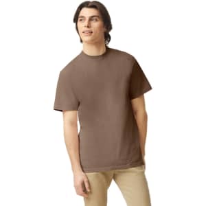 A brown heavyweight adult t-shirt displayed on a model, featuring short sleeves and a simple design.