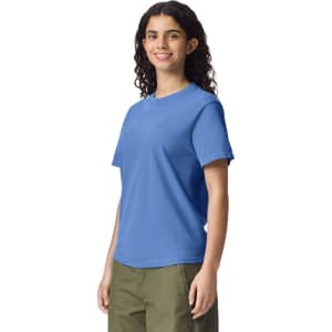 A blue heavyweight adult T-shirt displayed on a model, featuring a simple design and a logo.