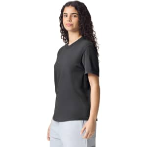 A black heavyweight adult t-shirt with short sleeves, displayed on a model. It features a logo on the shirt.