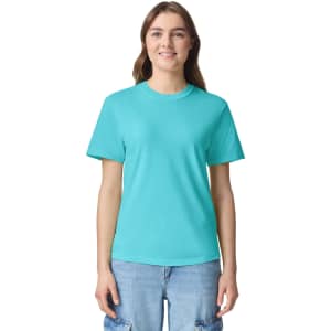 A turquoise adult heavyweight t-shirt displayed on a model, featuring a logo.