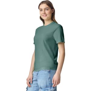 A green heavyweight t-shirt is displayed on a model, featuring a casual fit and a simple design.