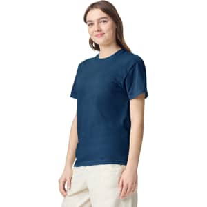 A navy blue adult heavyweight T-shirt displayed on a model, featuring a logo on the front.