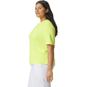 A side view of a bright yellow heavyweight t-shirt with a logo, displayed on a model.