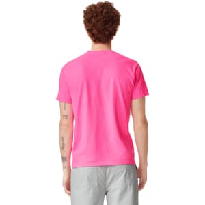 A back view of a bright pink heavyweight t-shirt featuring a logo. The shirt has a classic fit with short sleeves.