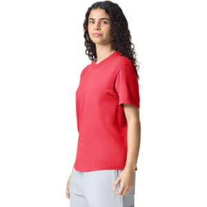A red heavyweight adult t-shirt displayed on a model with curly hair, featuring short sleeves and a relaxed fit.