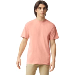 A short-sleeved, coral heavyweight T-shirt on a model, featuring a classic round neckline and no visible logos.