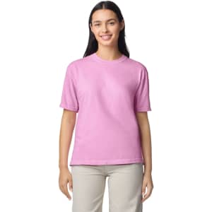 A pink adult heavyweight t-shirt displayed on a model, featuring short sleeves and a simple design.