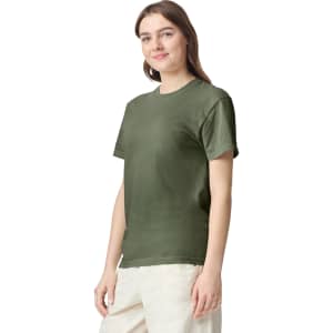 A woman models an olive green adult heavyweight T-shirt, featuring short sleeves and a crew neckline.