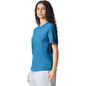 A blue heavyweight adult t-shirt on a model, featuring a round neckline and short sleeves.