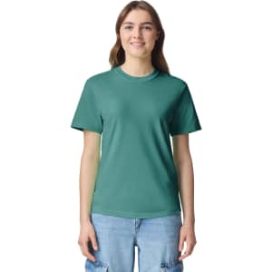 A green heavyweight adult T-shirt displayed on a model, featuring short sleeves and a crew neckline.
