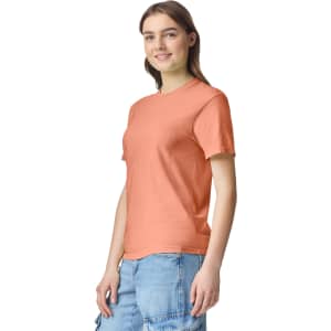 A peach heavyweight T-shirt featuring a round neck and short sleeves, displayed on a model.
