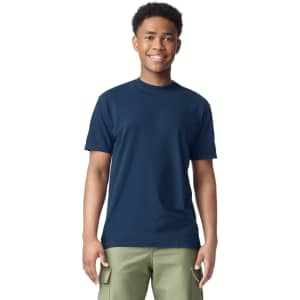 A navy blue heavyweight t-shirt is displayed on a young model, featuring a plain design and short sleeves.