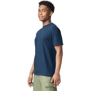 A navy heavyweight t-shirt is displayed on a model, featuring a simple design and a logo on the chest.