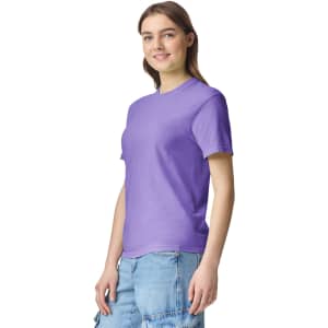 A purple adult heavyweight T-shirt displayed on a model, featuring a simple design and a logo.