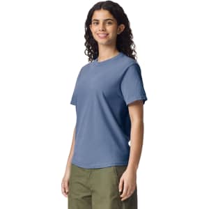 A blue heavyweight adult T-shirt on a model. The shirt features short sleeves and a relaxed fit.