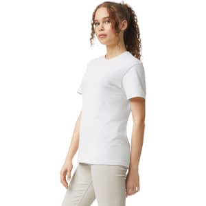 A white adult heavyweight t-shirt displayed on a model, featuring a plain design and a logo on the label.
