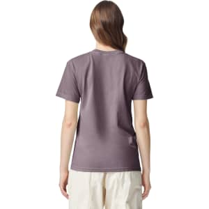 A back view of a women’s adult heavyweight t-shirt in a muted purple colour, featuring a logo.