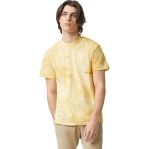 A heavy yellow tie-dye t-shirt displayed on a model, featuring a round neckline and short sleeves.