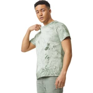 A heavyweight t-shirt in a green marble pattern, featuring a logo, worn by a model.