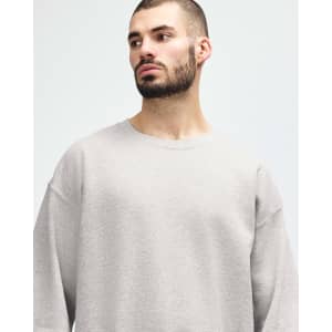 A grey Gildan Heavy Blend adult crewneck sweatshirt with long sleeves, featuring a logo.