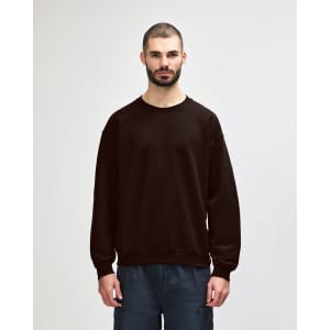 A brown Gildan Heavy Blend adult crewneck sweatshirt with long sleeves, worn by a model.