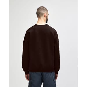A brown Gildan Heavy Blend adult crewneck sweatshirt, viewed from the back, paired with blue jeans.
