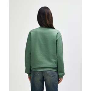 A green Gildan Heavy Blend adult crewneck sweatshirt viewed from the back, featuring long sleeves and a simple design.