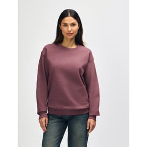 A maroon Gildan Heavy Blend adult crewneck sweatshirt with long sleeves and a relaxed fit. It features a logo.