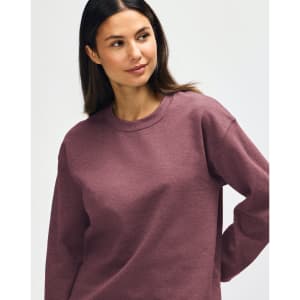 A maroon Gildan Heavy Blend adult crewneck sweatshirt displayed on a model with a neutral background.