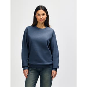 A crewneck sweatshirt in a blue hue, featuring long sleeves and a relaxed fit. It includes a logo on the garment.