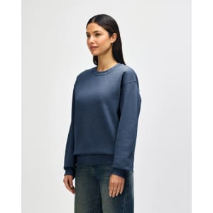 A blue Gildan Heavy Blend adult crewneck sweatshirt with long sleeves, featuring a logo on the front.