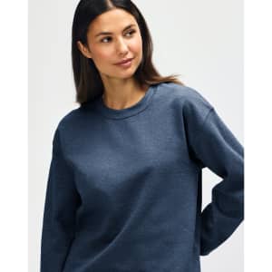 A blue Gildan Heavy Blend Adult Crewneck Sweatshirt on a model, featuring a casual fit and long sleeves.
