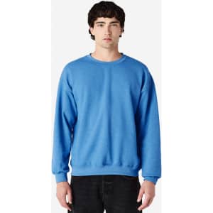 A blue Gildan Heavy Blend adult crewneck sweatshirt displayed on a model. The sweatshirt features a simple design and has a logo.