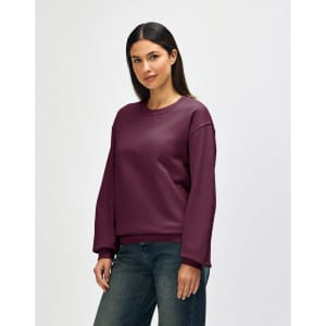 A burgundy Gildan Heavy Blend adult crewneck sweatshirt displayed on a model, featuring a simple design.