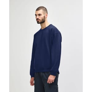 A navy Gildan Heavy Blend adult crewneck sweatshirt displayed on a model wearing blue jeans.