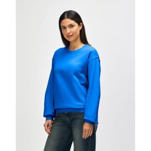 A blue Gildan Heavy Blend adult crewneck sweatshirt displayed on a model, featuring a casual fit and long sleeves.