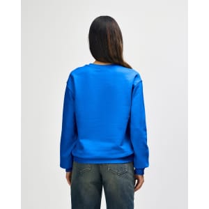 A blue Gildan Heavy Blend adult crewneck sweatshirt, view from the back, with a relaxed fit and long sleeves.