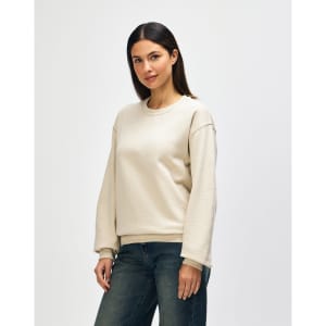 A beige Gildan Heavy Blend adult crewneck sweatshirt displayed on a model, with a plain design and relaxed fit.