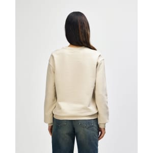 A cream-coloured Gildan Heavy Blend adult crewneck sweatshirt, featuring a logo, displayed from the back.
