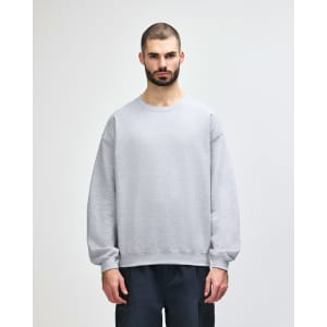 A grey Gildan Heavy Blend adult crewneck sweatshirt with long sleeves and a logo.