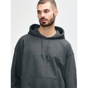A dark grey hooded sweatshirt is displayed, featuring a model with long hair and a subtle smile.