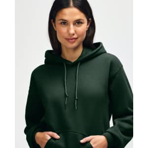 A green hooded sweatshirt worn by a woman with long hair, featuring a hood and a logo.